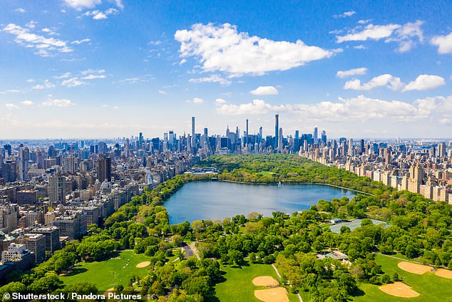 An aerial view shows Central Park, an 843-acre public park in the heart of Manhattan.  It is surrounded by dense residential and commercial buildings.