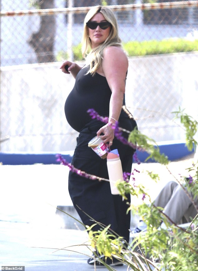 Hilary Duff showed off her growing baby bump while out and about in Los Angeles on Monday afternoon.