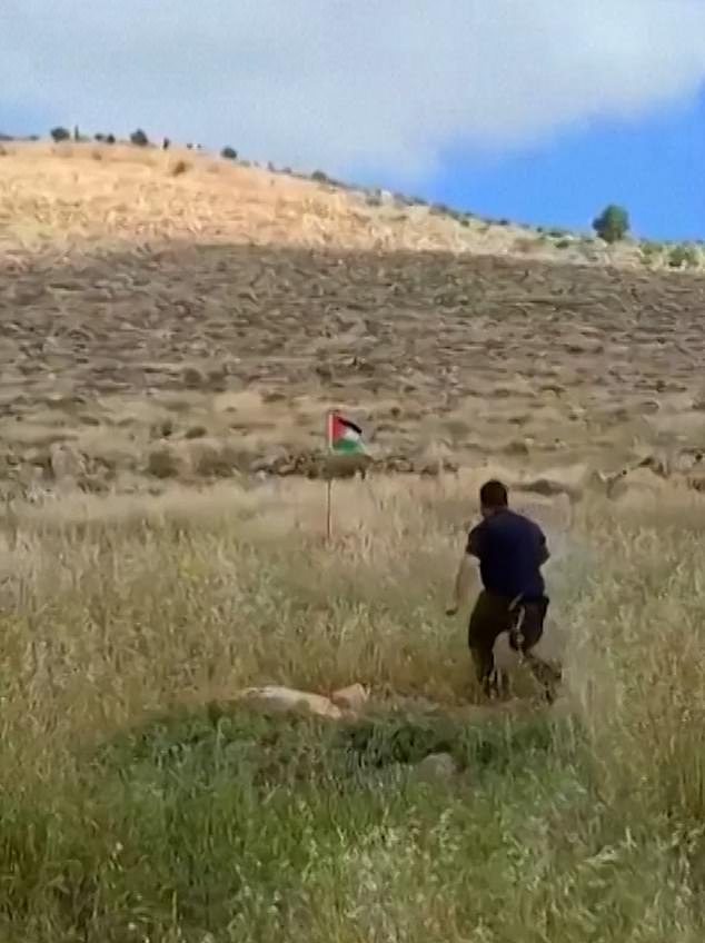 An IDF reservist can be seen attacking a Palestinian flag erected near the Kochav Hashahar settlement in the West Bank.