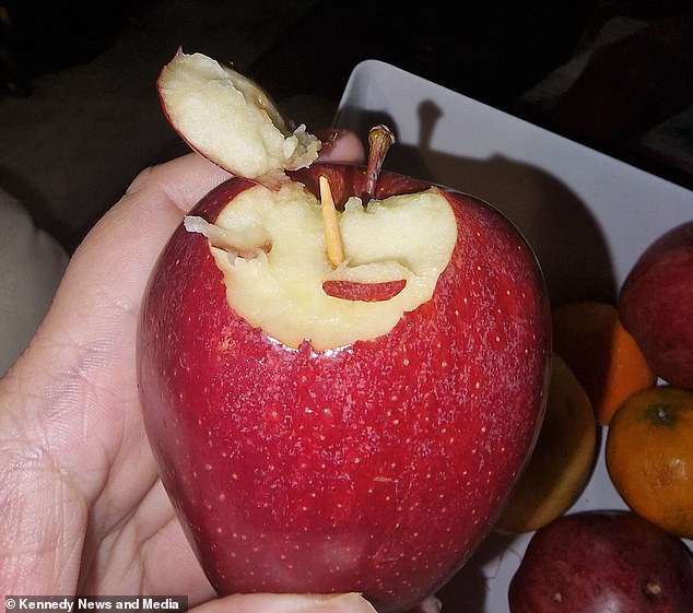 The mother of four claimed to have discovered what appeared to be sharp toothpicks inside the red apple (pictured).