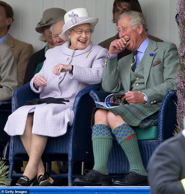 Then-Prince Charles, now king, and his mother, the late Queen Elizabeth, laugh while watching a children's sack race in Scotland in 2012.