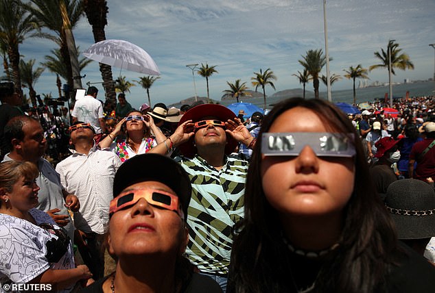 People use special protective glasses to observe a total solar eclipse in Mazatlan, Mexico, April 8, 2024. The only eclipse glasses that are safe for viewing the eclipse are those labeled 'ISO 12312-2' or 'ISO 12312- 2:2015.'