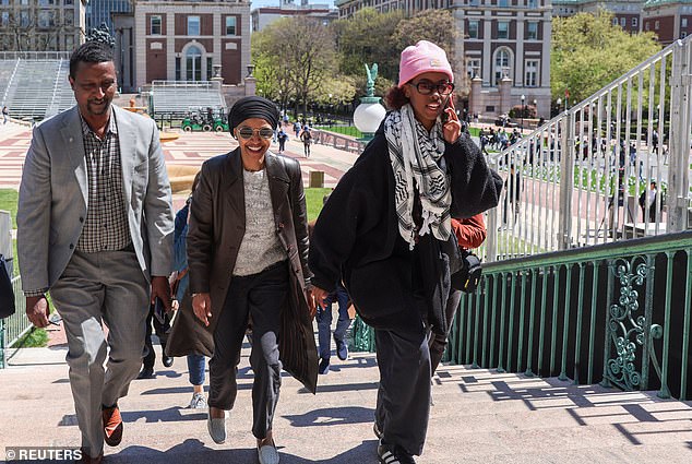 Rep. Ilhan Omar, D-Minn. (center), walks across the Columbia University campus with her recently suspended daughter Isra Hirsi (right).