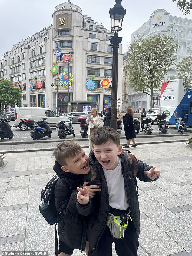 Brody, 11 (right) and Romeo, 7 (left), smile in Paris to celebrate their mother's big 40th birthday.