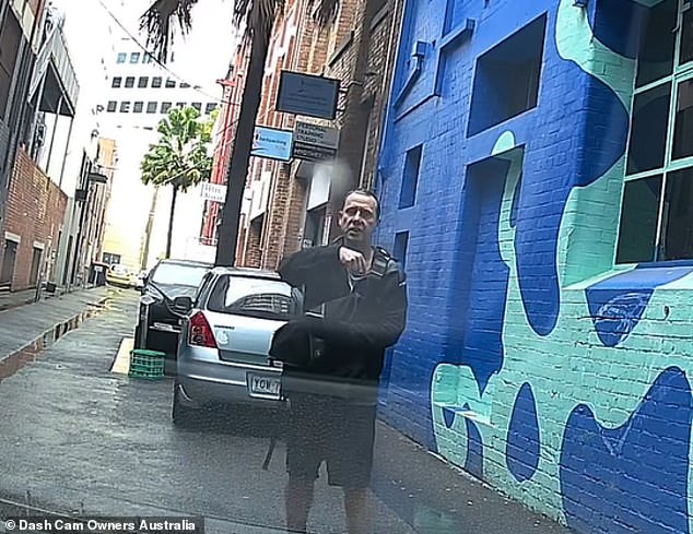 A pedestrian who tried to reserve a parking space for a friend by stopping in an empty space in an alleyway in Melbourne (pictured) sparked a confrontation with another motorist.