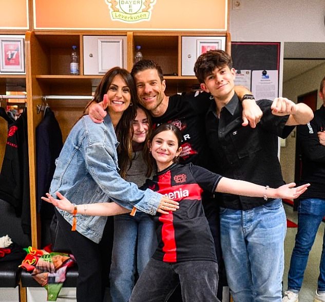 Xabi Alonso poses with his wife Nagore and their three children Jontxu, Ane and Emma after Bayer Leverkusen won a historic Bundesliga title last weekend.