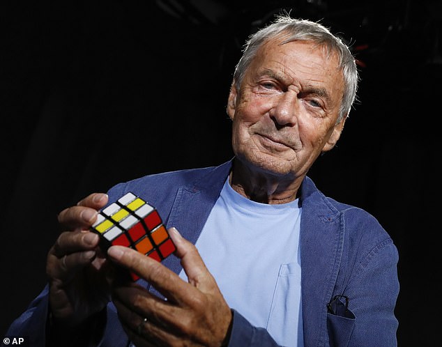 Game director: Erno Rubik with one of his classic cube puzzles.