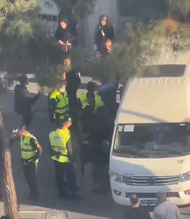 This video (pictured) emerged last month and shows officers arresting women and putting them into white vans as part of Tehran's crackdown on women's clothing.