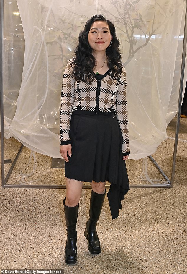 Crazy Rich Asian star Awkwafina, 35, wore a plaid sweater and pleated black skirt with knee-high patent leather boots.