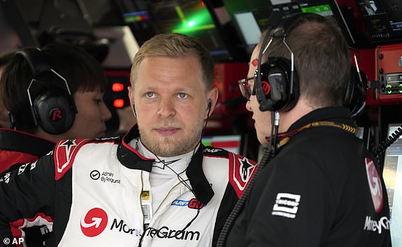 Danish Haas driver Kevin Magnussen waits in the garage before the second free practice session at the Suzuka circuit in central Japan, Friday, April 5, 2024, ahead of Sunday's Japanese Formula One Grand Prix . (AP Photo/Hiro Komae)