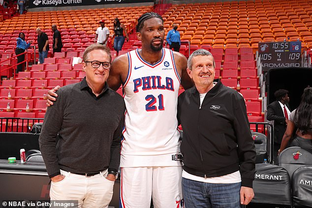 Miami Dolphins CEO and F1 Miami Managing Partner Tom Garfinkel, NBA star Joel Embiid and Miami GP ambassador Guenther Steiner (left-right) pose after the game.