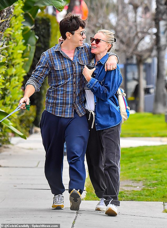 For their relaxed date, the actor, 45, wore a blue and brown flannel over an orange T-shirt, navy joggers and sneakers.