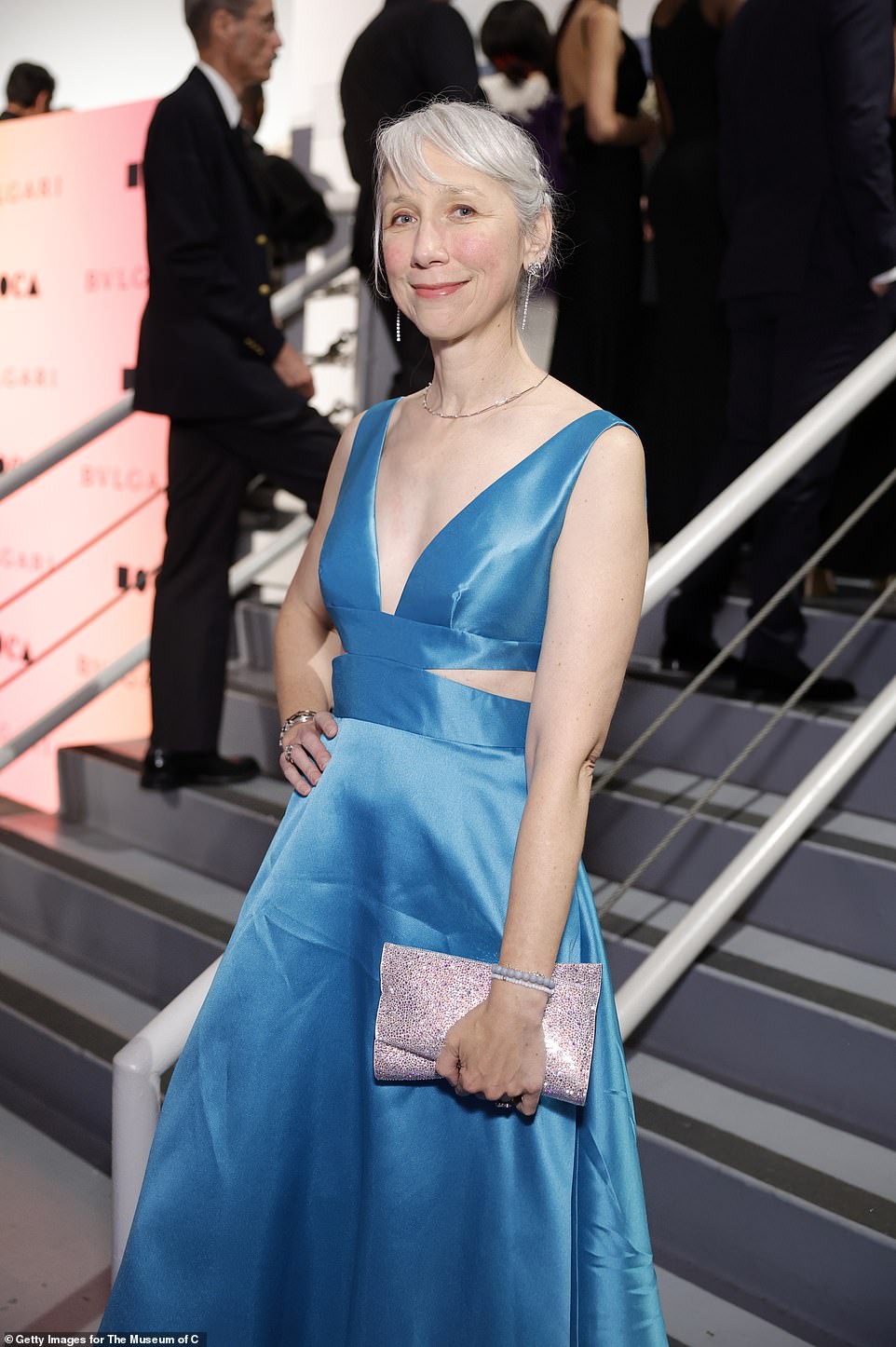 Alexandra paired a dazzling pink clutch with her dress
