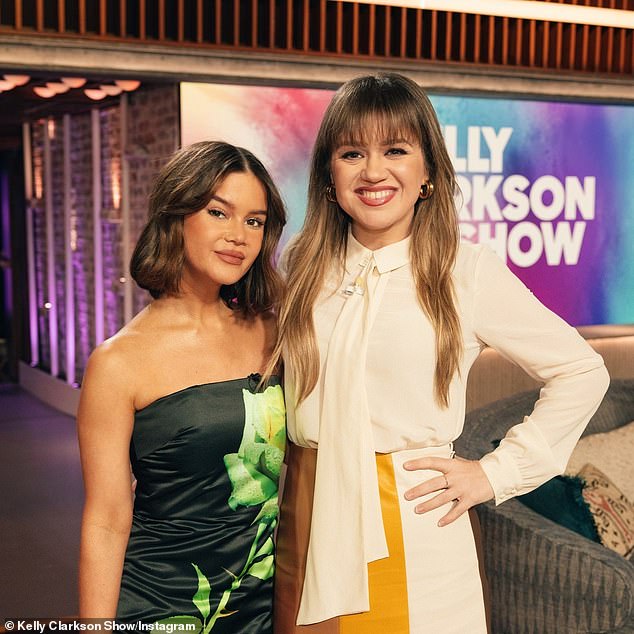 Kelly Clarkson showed off her incredible figure in a cute ivory suit and high heels on her talk show on Friday.  The American Idol veteran, 41, had as her main guest country singer Maren Morris, who wore a strapless black dress with a green design on the front of her.