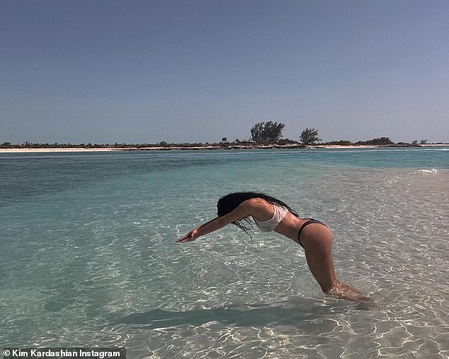 Kim Kardashian posted a gallery of photos on Instagram on Wednesday from her vacation in the Turks and Caicos Islands, including one of her inexplicably wading into knee-deep water.