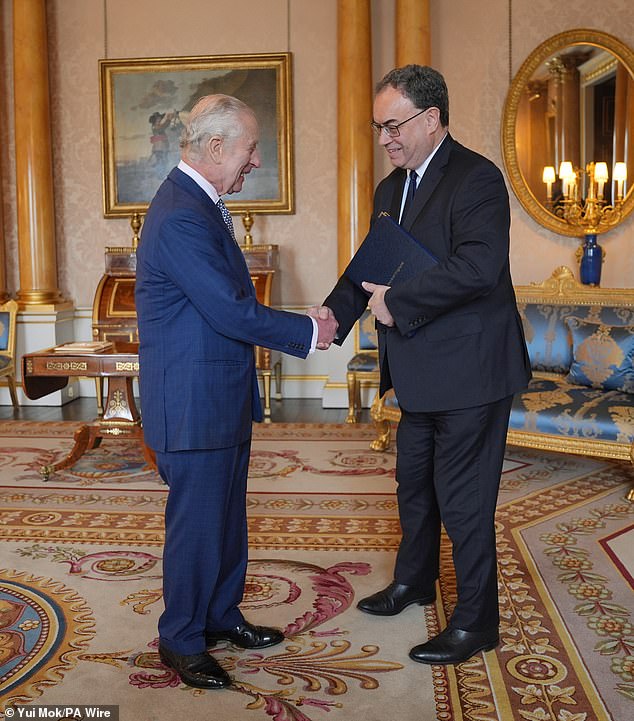 King Charles III (left) receives the first banknotes bearing his portrait from Bank of England Governor Andrew Bailey at Buckingham Palace.