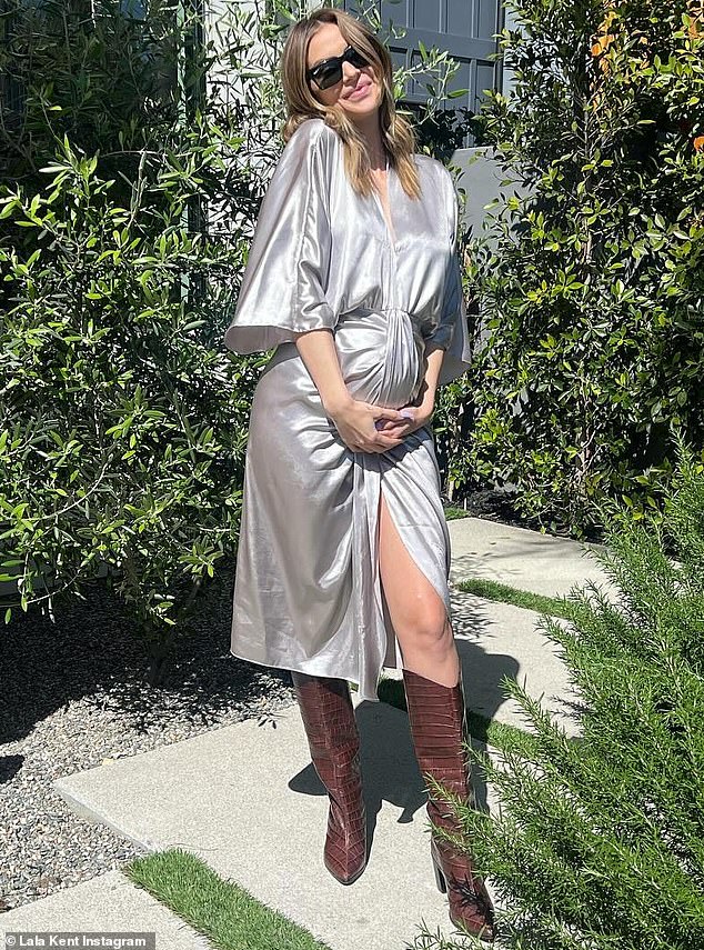 Vanderpump Rules star Lala Kent cradled her burgeoning baby bump in a wrap dress while sharing her gratitude for her sperm bank on Wednesday.