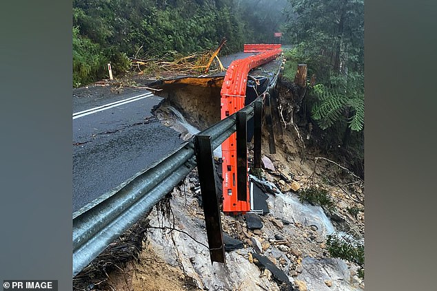 The only sealed road in or out of the city, Megalong Road, was badly damaged after the deluge caused a landslide on Saturday (pictured).