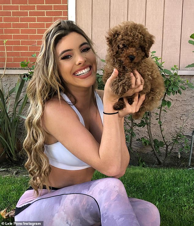 The YouTube star, 27, made the chilling admission while playing the Family Feud-inspired game Rent Free for Bilt Rewards, showing off his injured hand;  she appears in the photo with the dog Toby.