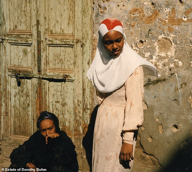 A stunning array of photographs revealed in a new exhibition celebrates the work of photographer Dorothy Bohm, who escaped the Nazis and built a life in Britain.  Above: Two women in Aswan, a city in southern Egypt, in 1987.