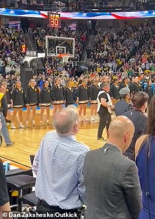 Iowa players listened to the US national anthem before their game against LSU