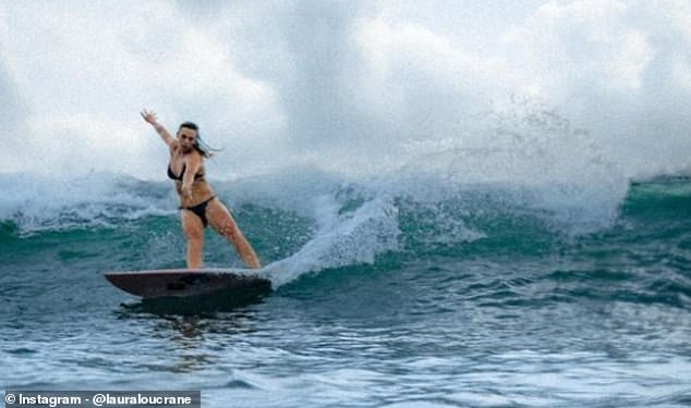 Love Island star Laura Crane has become the first British woman to surf 60ft waves in Nazaré, Portugal.