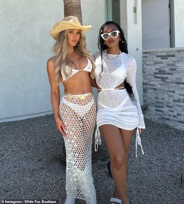 Jessie Wynter donned a skimpy white bikini top, cowboy hat and matching mesh skirt as she posed for photos with Jourdan Riane.