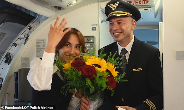 Captain Konrad Hanc (pictured, right) brought passengers and crew to tears when he introduced himself over the plane's intercom system before getting down on one knee and popping the question.