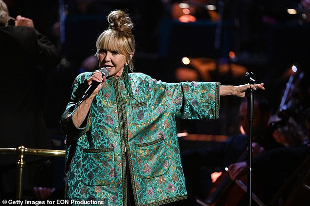 Lulu, 75, has been confirmed for Glastonbury Festival after detailing her retirement from touring and plans for a new album (pictured on stage in 2022).