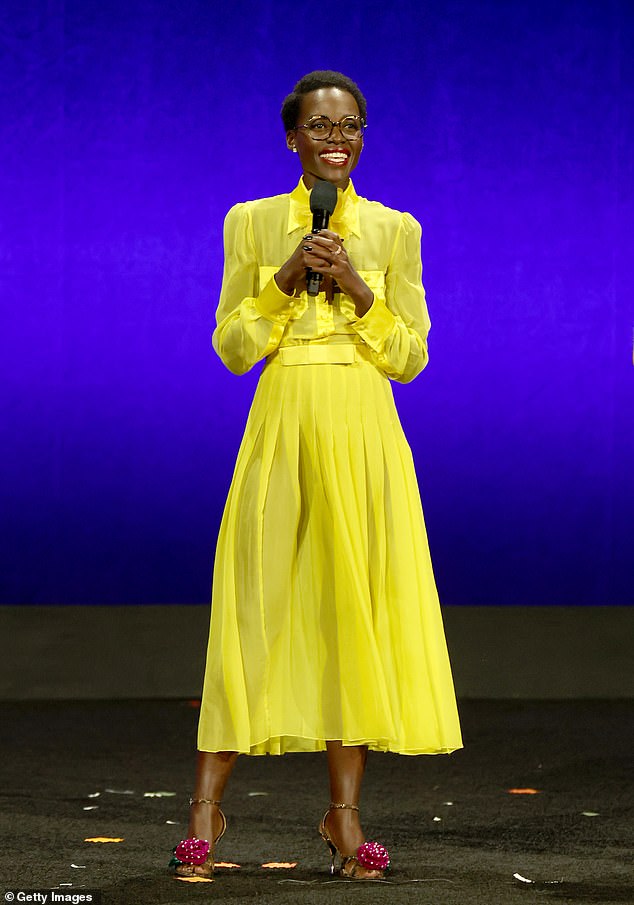 Lupita Nyong'o showed off her sophisticated sense of style in a yellow shirt dress while giving a sneak peek of her animated film The Wild Robot at CinemaCon on Wednesday.