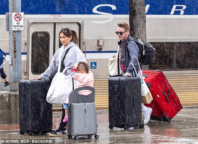 Macaulay Culkin, 43, and Brenda Song, 36, were caught soaked by the rain while arriving with their children at the Burbank train station.