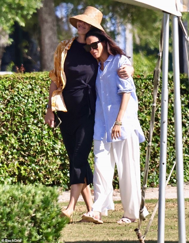 Meghan Markle, seen here with a hat-clad woman believed to be Delfina Blaquier, traded in her stilettos for $760 Hermes flip-flops and fresh linens a day after being mocked for her impractical outfit at the field at a charity polo match in Miami, Florida.