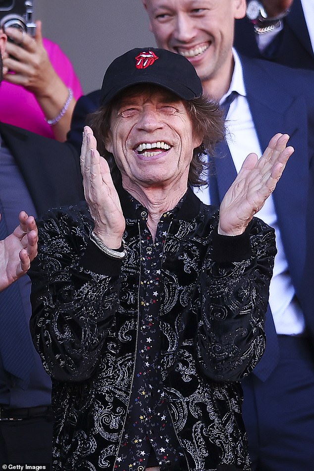 The Rolling Stones' frontman Mick Jagger, pictured enjoying a concert in Barcelona in October last year.  The band have earned a staggering $180m (£142m) in nine years.