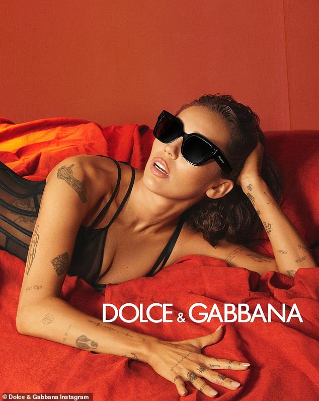 Miley Cyrus donned chunky black shades and matching sheer lingerie in new photos from her Dolce & Gabbana eyewear campaign.