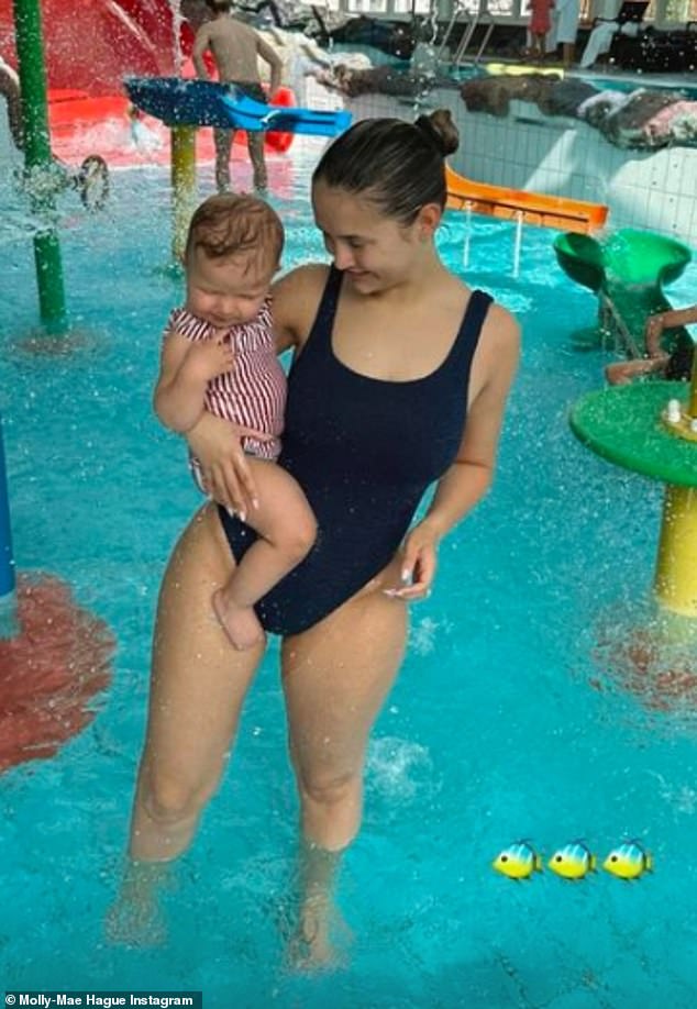 Molly-Mae Hague showed off her figure in a black swimsuit as she sweetly doted on her daughter Bambi during a family weekend.