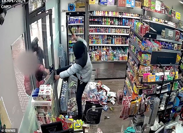 The machete-wielding thief tries to escape the store after getting trapped inside by the shopkeeper.