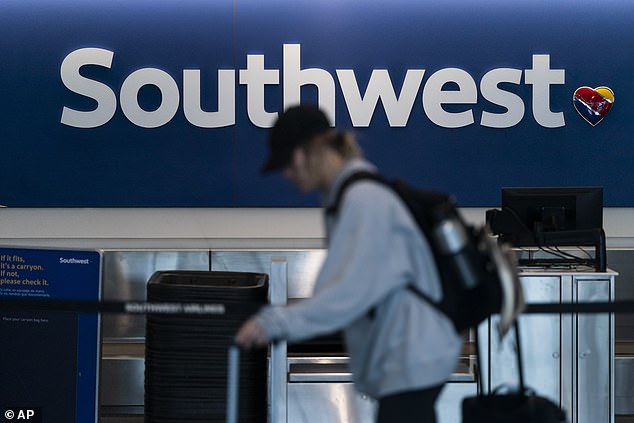 A traveler walks through the Southwest ticket counter area at Los Angeles International Airport in Los Angeles, April 18, 2023.