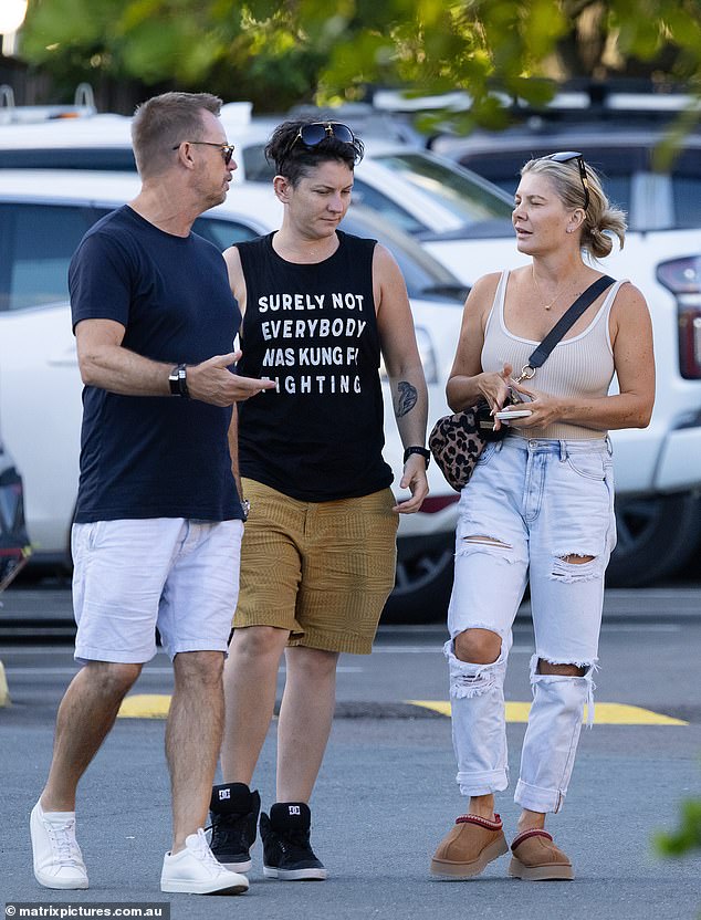 The Rogue Traders singer was spotted out and about with her non-binary lover in Queensland on Saturday as the pair ran errands with a friend (left)