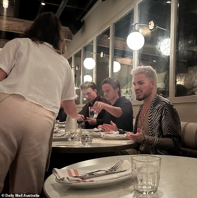 There was no VIP treatment for American star Adam Lambert at Justin Hemmes' restaurant The Paddington in Sydney on Wednesday night.  In photos provided exclusively to Daily Mail Australia, the American singer, 42, appeared frustrated after a waitress asked her to come to his table.