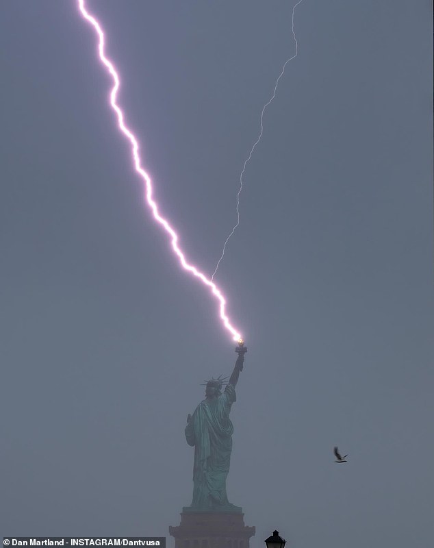 A large lightning bolt was seen striking the Liberty State directly above the torch flame Wednesday night.