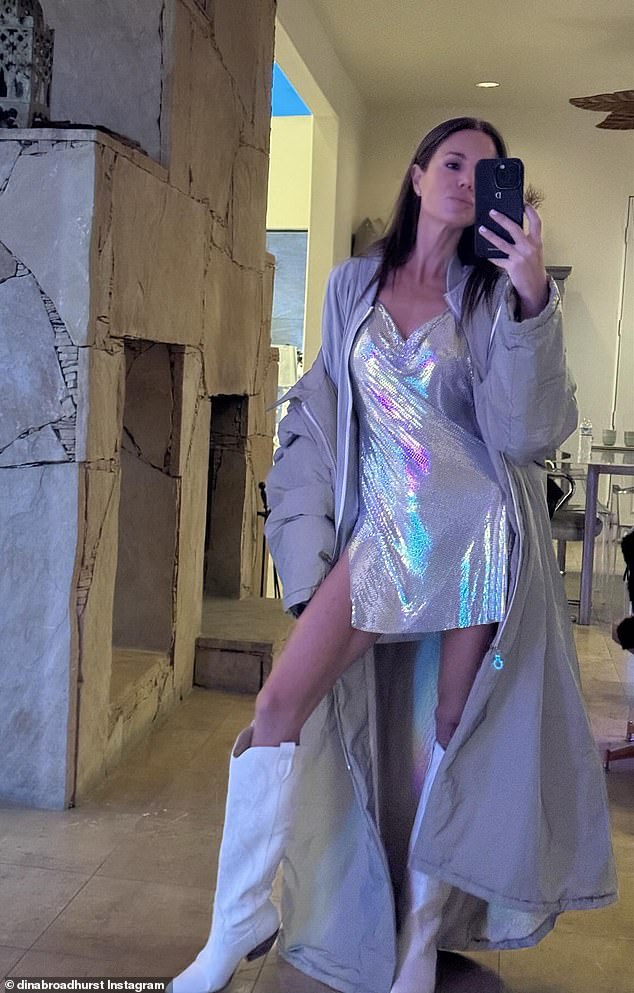 For the occasion, Dina nailed festive chic in a sparkly silver minidress, which she paired with a gray puffer jacket and knee-high white cowboy boots.