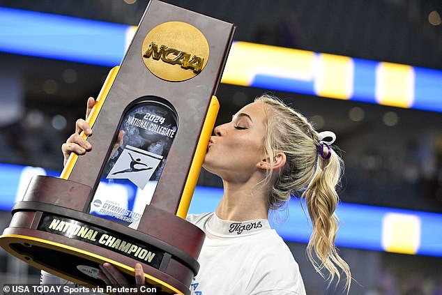Dunne celebrates with the national championship trophy after LSU's victory on Saturday.