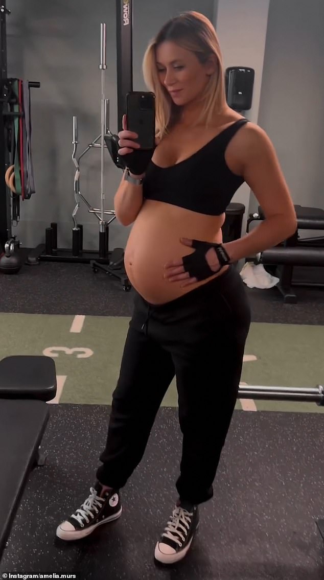 Olly Murs' pregnant wife Amelia showed off her baby bump in a black sports bra while working out on Monday.