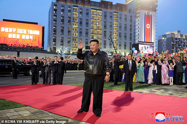 North Korea's burly ruler Kim Jong Un has been photographed wearing exceptionally baggy trousers (pictured) as he walks the red carpet at a ceremony this week.