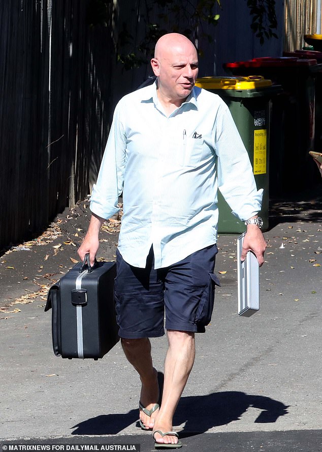 A doctor with medical equipment is seen leaving Kent's home on Sunday.