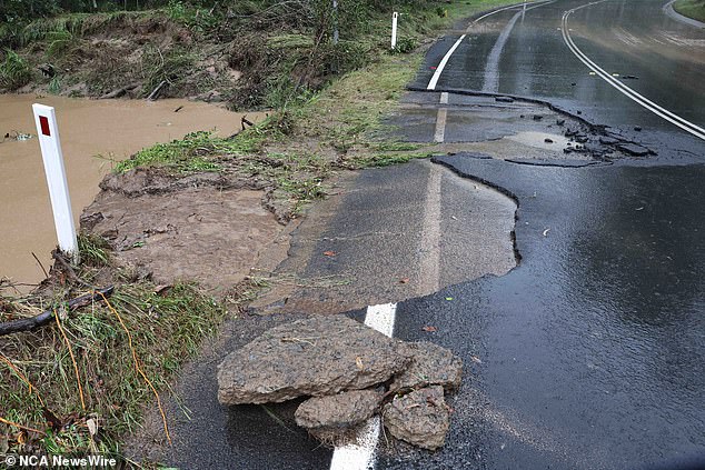 Greenbank received 150mm of torrential rain overnight and on Thursday as part of a rain bomb that hit Queensland and New South Wales (pictured, damage in Greenbank)