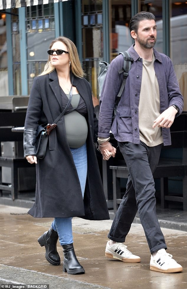 Pregnant Emily Atack, 34, was spotted on a rare outing with her boyfriend Dr Alistair Garner as they enjoyed a romantic walk hand-in-hand in London on Friday.
