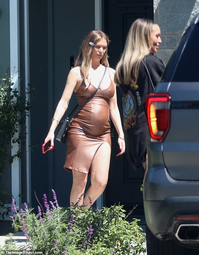 Vanderpump Rules star Lala Kent confidently flaunted her growing baby bump in a brown leather dress while out and about with Scheana Shay in Los Angeles.
