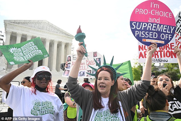 Pro-abortion rights protesters gathered outside the Supreme Court on Wednesday ahead of arguments over whether Idaho's abortion ban conflicts with the federal EMTALA.