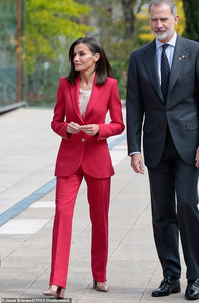 Queen Letizia of Spain (pictured) wore a striking red pantsuit to attend an event commemorating Spanish Olympians from the 1992 Games. King Felipe (pictured, right), who participated in the Games 1992 Olympics, he looked equally dapper in a pinstripe suit.